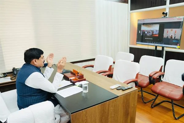 कार्यालय में मेज पर बैठे मुख्यमंत्री डॉ. मोहन यादव सामने लगी स्क्रीन के जरिए ऑनलाइन कार्यक्रम को संबोधित करते हुए